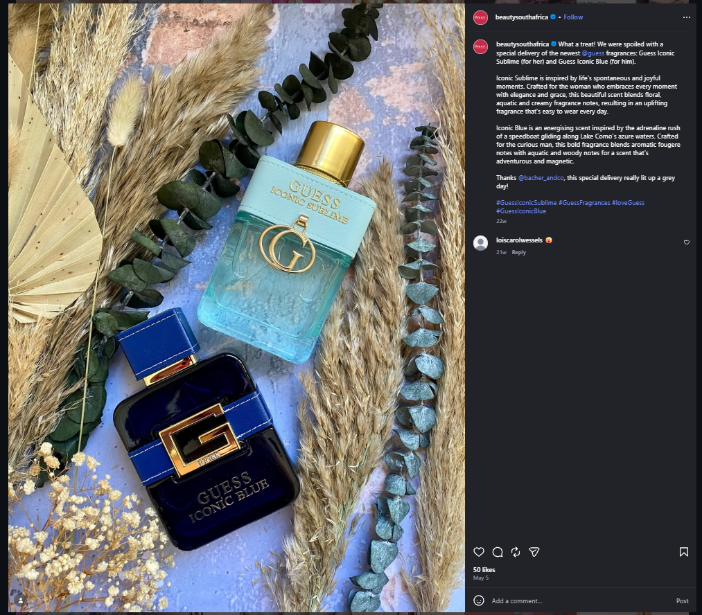 GUESS Iconic Sublime and Iconic Blue fragrances styled with eucalyptus, dried grasses and a textured blue background